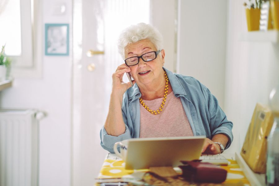 neutral mature woman with phone istock 1368188565 (1)